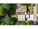 Overhead view showcasing the home's roof, detached garage, driveway, and surrounding landscaping at 7165 Cr 655, Bushnell, FL 33513