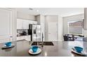 Modern kitchen featuring a large sink, breakfast bar, stainless steel appliances and ample cabinet space at 3282 Armstrong Ave, Clermont, FL 34714