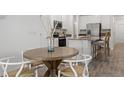 Eat-in kitchen with stainless appliances, light countertops, and a dining table with seating for four at 5611 Vinyasa Rd, Clermont, FL 34714