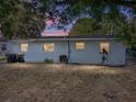 Exterior shot showcasing the back of the house with windows and a grassy area at 1205 Crestwood Dr, Winter Haven, FL 33881