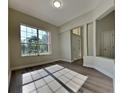 Bright and spacious living room with large windows and wood-look flooring at 210 Alta Vista St, Debary, FL 32713