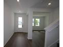 Elegant entryway with dark laminate flooring and neutral color palette throughout at 6069 Sacred Oak Ave, Mount Dora, FL 32757