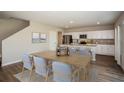 Well-lit kitchen featuring modern appliances, an island with bar seating, and a dining area with seating for six at 1046 Foreshore Ln, Haines City, FL 33844