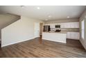 Open-concept living space with modern kitchen, stainless appliances, and plenty of room for entertaining at 1046 Foreshore Ln, Haines City, FL 33844