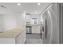 Bright kitchen featuring stainless steel appliances, granite countertops, and ample cabinet space at 431 Caribbean Ct, Poinciana, FL 34759