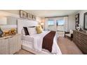 Serene main bedroom featuring a plush bed, decorative wall art, and ample natural light at 1054 Foreshore Ln, Haines City, FL 33844