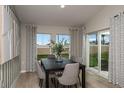 Dining area with a modern table, stylish chairs, and sliding glass doors that lead to the outdoor space at 1590 Sage Ave, Haines City, FL 33844