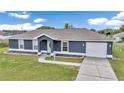 Charming single-story home featuring a well-maintained lawn and paved driveway at 326 Marion Oaks Trl, Ocala, FL 34473