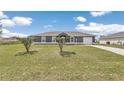 Charming single-story home with a well-maintained lawn and driveway on a beautiful sunny day at 326 Marion Oaks Trl, Ocala, FL 34473