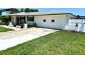 Exterior view showcasing a two-car garage and well-kept lawn, offering convenient parking at 1913 Poinsetta Ln, Maitland, FL 32751