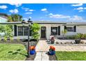 Inviting single-story house showcasing a beautifully landscaped front yard and stylish entrance at 1913 Poinsetta Ln, Maitland, FL 32751