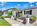 Well-maintained home featuring elegant landscaping with decorative rocks and vibrant potted plants at 1913 Poinsetta Ln, Maitland, FL 32751