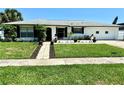 Traditional home boasting a lush front lawn and a quaint walkway leading to the entrance at 1913 Poinsetta Ln, Maitland, FL 32751