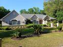Lovely single-story home boasting manicured lawn and lush tropical landscaping at 19811 Lake Dorr Rd, Altoona, FL 32702