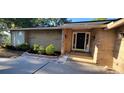 Inviting entryway with a well-lit porch and neatly landscaped flowerbeds offering enhanced curb appeal at 1524 New Jersey Oaks Ct, Lakeland, FL 33801