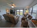 Living room with sliding glass doors to the outdoor, ceiling fan and comfortable furniture at 3100 Ocean Shore Blvd # 101, Ormond Beach, FL 32176
