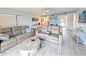 Cozy living room with leather sofas, nautical decor, and views into the kitchen at 3100 Ocean Shore Blvd # 101, Ormond Beach, FL 32176