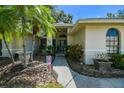 Inviting front entrance with blue door, lush landscaping, and decorative walkway at 4346 Thomas Wood Ln E, Winter Haven, FL 33880
