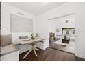 Charming dining area with built in seating and an adjacent living room at 1105 Chichester St, Orlando, FL 32803