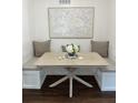 Close up of dining area showcasing the table, cushions, built-in bench seating and modern decor at 1105 Chichester St, Orlando, FL 32803