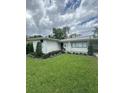 Charming single story home with white painted siding, well-maintained lawn, and mature landscaping at 1105 Chichester St, Orlando, FL 32803