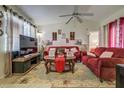 Inviting living room featuring a vaulted ceiling, tile floors, and comfortable seating at 56 Pine Trak # 101E, Ocala, FL 34472