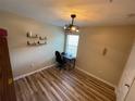 Bedroom featuring a modern light fixture, luxury vinyl floors, a window, and a neutral paint at 6059 Twain St # 108, Orlando, FL 32835