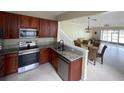 Bright, updated kitchen featuring stainless appliances, granite counters, and ample cabinet space at 6059 Twain St # 108, Orlando, FL 32835