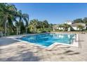 Community pool with palm trees and a clubhouse, great for relaxing and socializing at 6059 Twain St # 108, Orlando, FL 32835