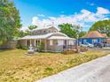 Charming home with a unique architecture, landscaping, and a driveway at 70 N Oak Ave, Umatilla, FL 32784