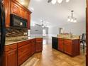 Kitchen with granite countertops, custom cabinets, tile backsplash, and stainless steel appliances at 994 Country Lake Cir, Lake Wales, FL 33898