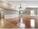 Bright and airy living room featuring a vaulted ceiling, hardwood floors, and lots of natural light at 994 Country Lake Cir, Lake Wales, FL 33898