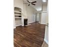 Open living space with vaulted ceiling, fireplace and built-in shelving at 1608 Fox Glen Ct, Winter Springs, FL 32708