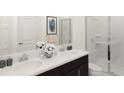 Bathroom featuring double sinks, a modern vanity, and a glass-enclosed shower at 2115 Forage Dr, Kissimmee, FL 34746