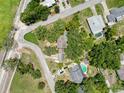 Aerial view of a home surrounded by mature trees and manicured landscaping at 800 W Lake Elbert Ne Dr, Winter Haven, FL 33881