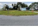 A single-story blue home with a large yard and an adjacent parked vehicle, set on a corner lot at 5137 Polaris St, Orlando, FL 32819