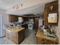 Functional kitchen featuring ample counter space, wood cabinets, modern appliances, and tiled flooring at 401 Pine Dr, Sanford, FL 32773