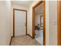 Inviting entryway featuring tile flooring, a white front door, and wood trim at 492 Caribbean Dr, Lakeland, FL 33803