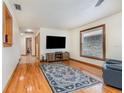 Bright living room with hardwood floors, large windows, and neutral wall colors at 492 Caribbean Dr, Lakeland, FL 33803