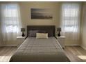 Comfortable bedroom with a queen bed, soft bedding, and matching bedside tables with lamps at 2057 Swift Rd, Oviedo, FL 32766