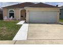 Charming single-story home featuring a manicured lawn, two-car garage and inviting entryway at 2057 Swift Rd, Oviedo, FL 32766