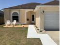 Charming single-story home featuring a manicured lawn, two-car garage and inviting entryway at 2057 Swift Rd, Oviedo, FL 32766
