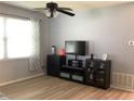 Living room featuring ceiling fan and a flat screen TV mounted on top of a black media center at 2057 Swift Rd, Oviedo, FL 32766