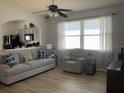 Open-concept living area features hardwood floors and a large window at 2057 Swift Rd, Oviedo, FL 32766