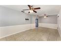 Bright living room features tile flooring, updated paint, and ceiling fans at 220 Escambia Dr, Winter Haven, FL 33884
