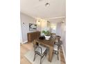 Bright dining room with stylish table, seating for four, modern art and wood floors at 2201 Flamingo Ave, Deltona, FL 32738