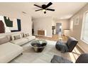 Bright living room with modern furnishings, ceiling fan, neutral colors and wood-look flooring at 2201 Flamingo Ave, Deltona, FL 32738