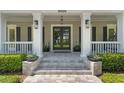 Elegant front entrance features a modern glass door and manicured landscaping at 5500 W Lake Butler Rd, Windermere, FL 34786