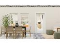 Outdoor patio area with dining set, stylish rug and neutral tones creates a cozy atmosphere at 7314 Ivy Tendril Ave, Orlando, FL 32829