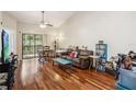 Bright living room with hardwood floors, vaulted ceilings and large glass sliding doors to balcony at 7759 Sugar Bend Dr # 7759, Orlando, FL 32819